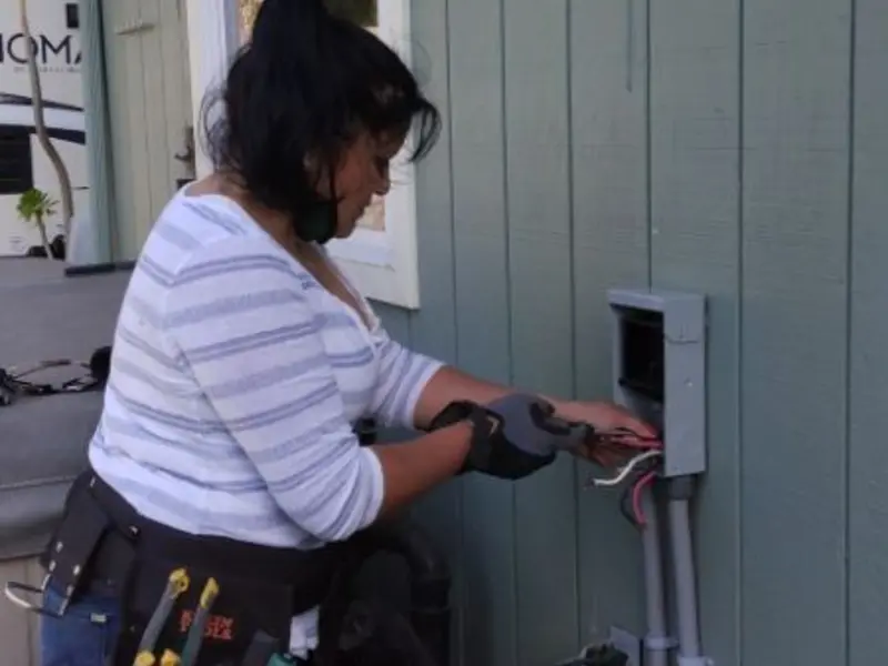 Licensed electrician wiring an exterior subpanel in Lighthouse Point